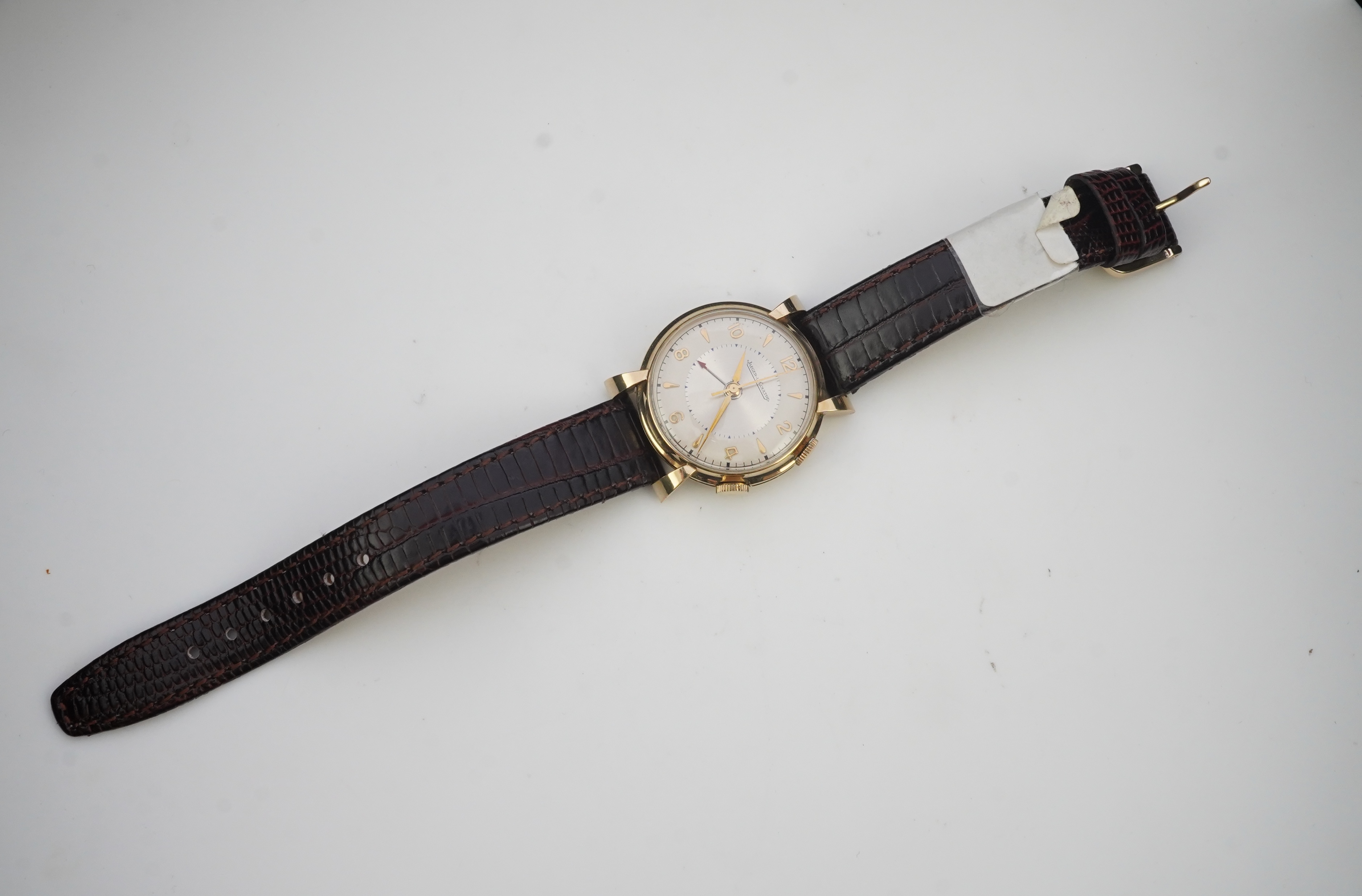 A gentleman's 1950's gold plated Jaeger LeCoultre Memovox manual wind wrist watch, on a later associated leather strap